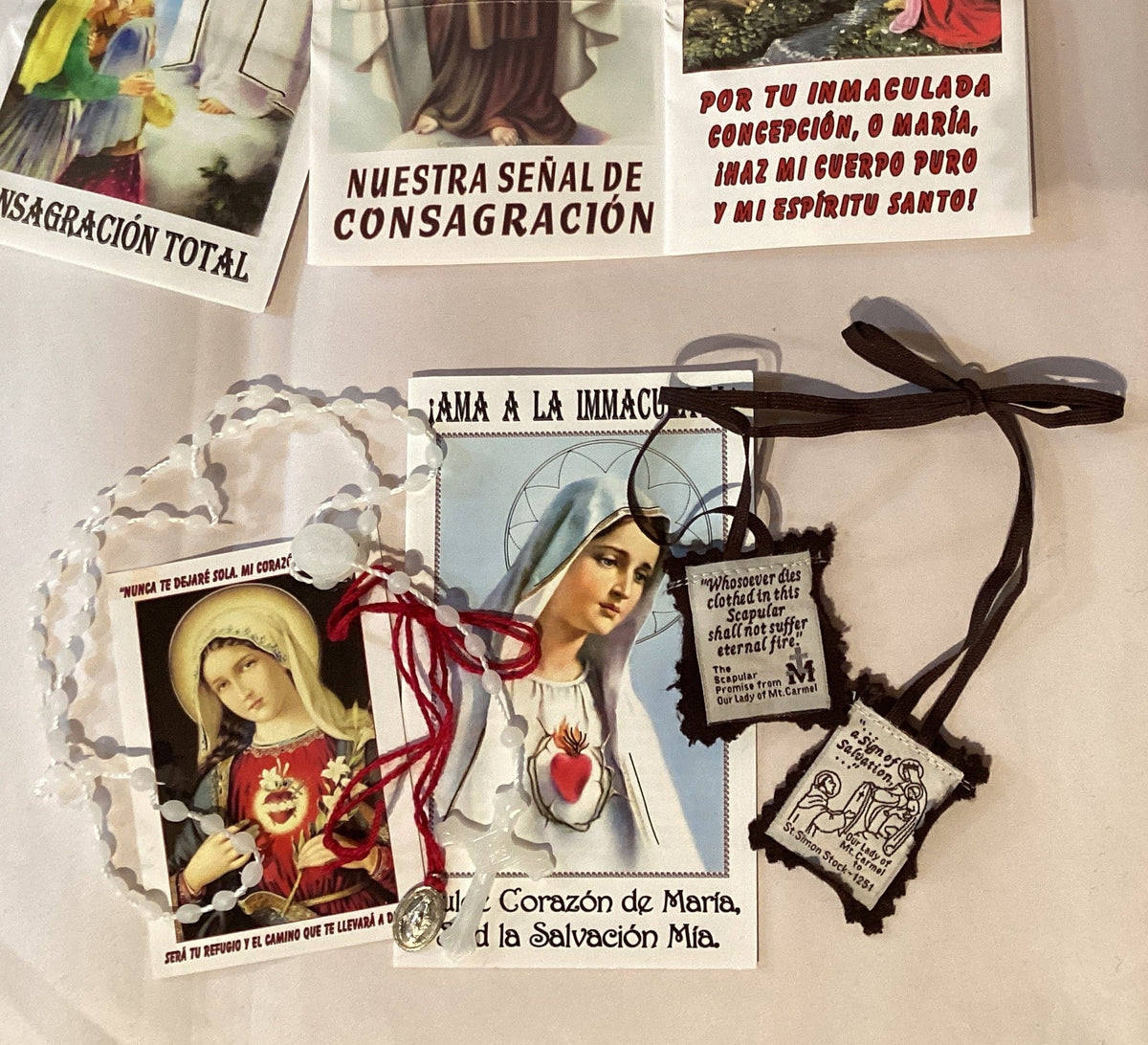 Catholic Immaculate Conception prayer set with rosary, scapular, medal, and prayer cards, featuring religious symbols and Catholic devotion.