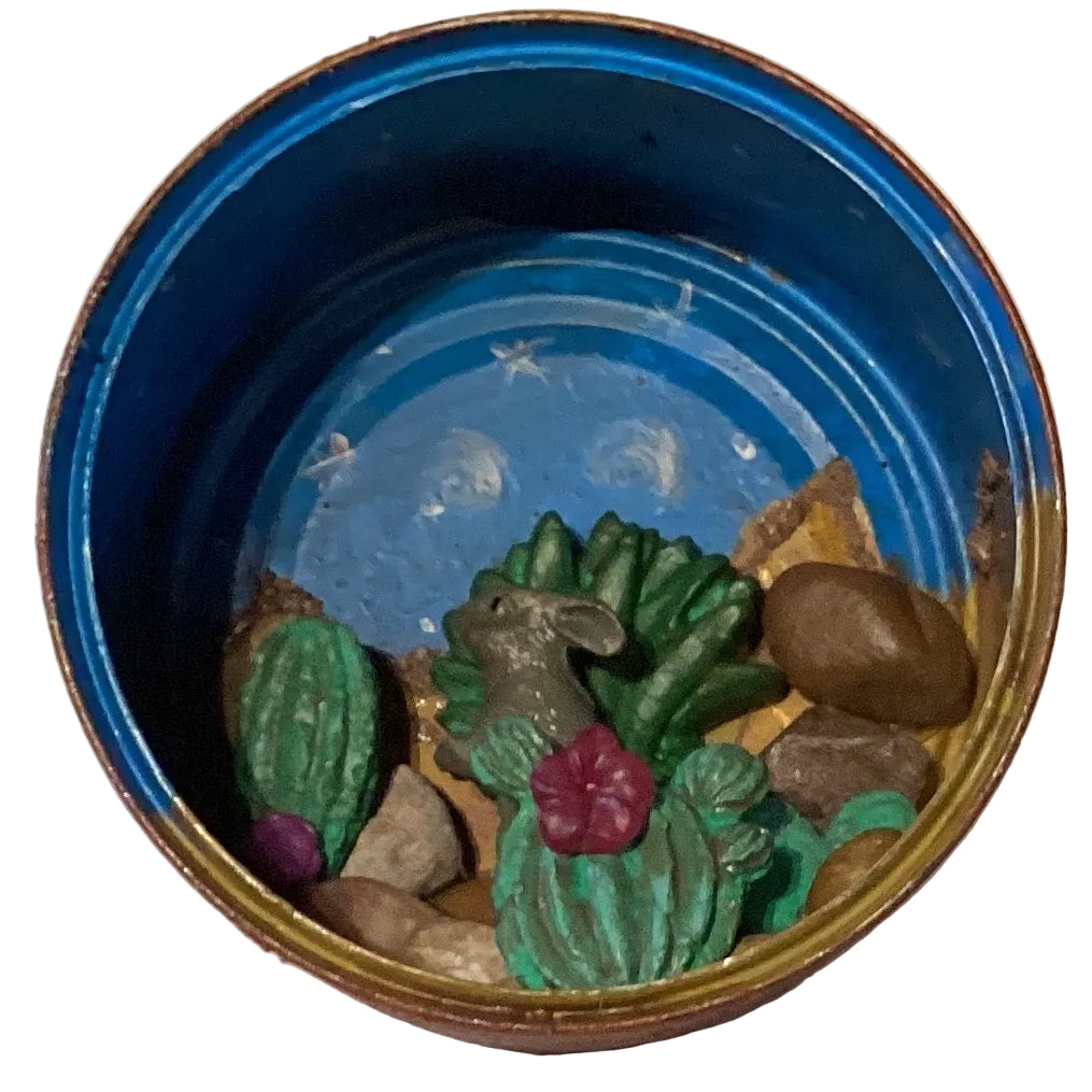 Decorative tin Western ambiance terrarium with miniature cacti and desert scene, crafted by Ysleta Mission Gift Shop.
