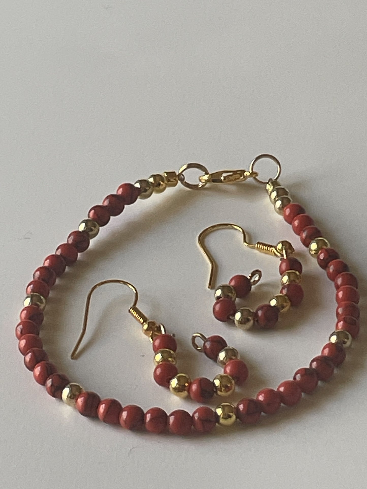 Red stone bead bracelet with 1-inch dangle earrings, gold spacer beads, hooks, and lobster clasp, by Sylvia Leroux jewelry set.