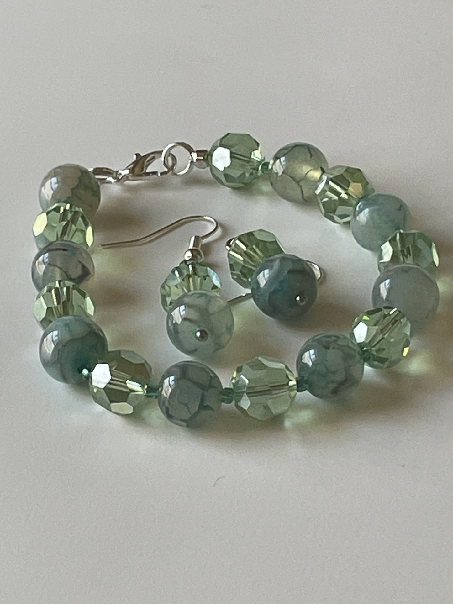 Sylvia Leroux clear green faceted bead bracelet with matching dangle earrings, 7-inch bracelet, silver lobster clasp and ear hooks.