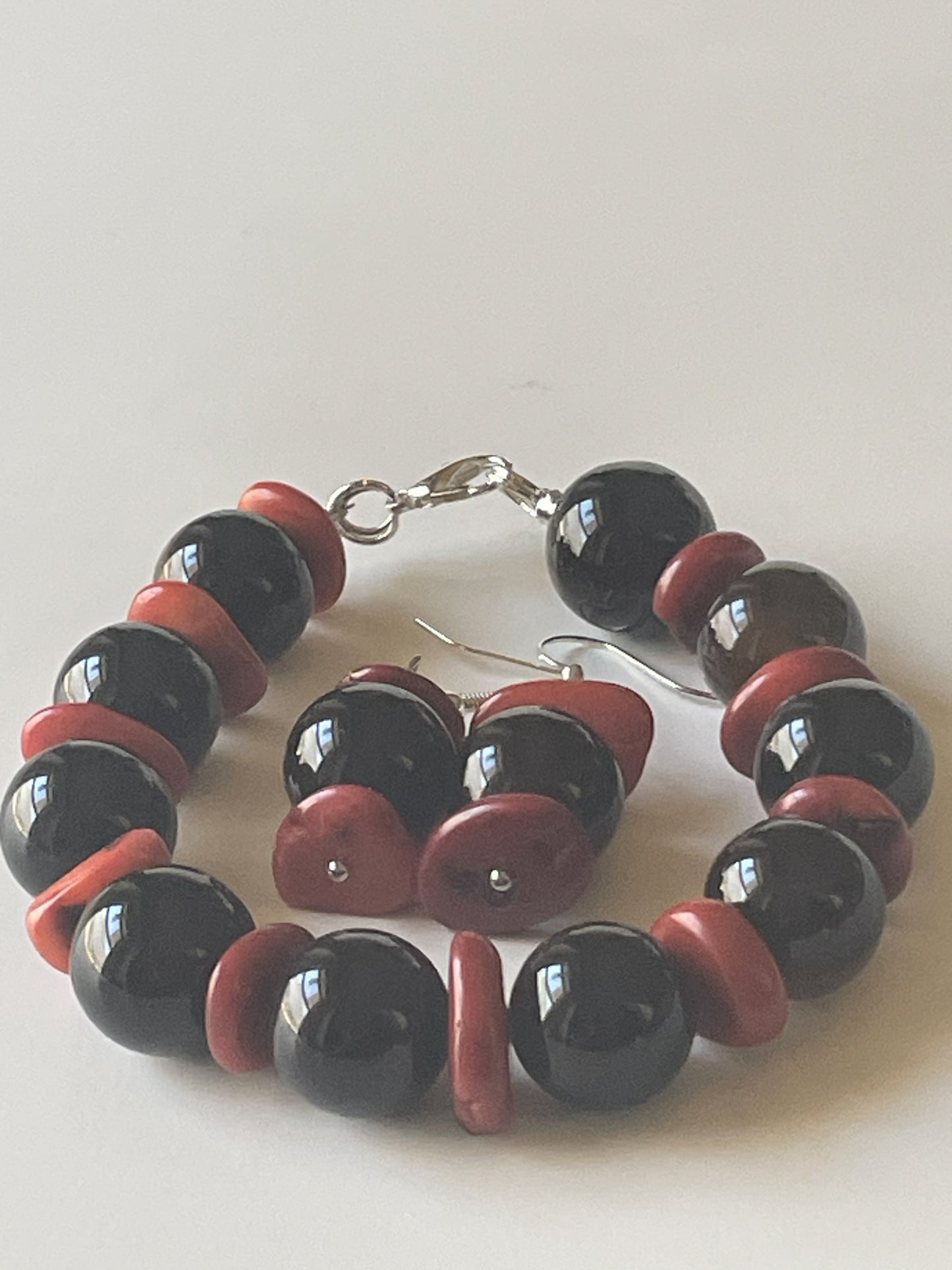 Brown agate bracelet and matching red jade dangle earrings from Sylvia Leroux, featuring silver clasps and hooks.