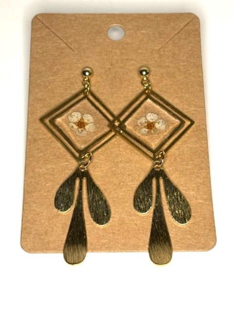 Gold geometric dangling earrings with pressed flower accents by Melissa Cortinas, featuring intricate jewelry design and floral details.
