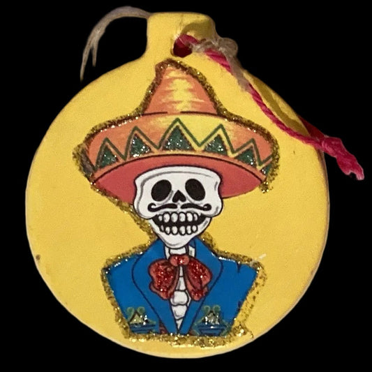 Colorful Día De Los Muertos ceramic ornament from Ysleta Mission Gift Shop, featuring traditional skull and floral designs.