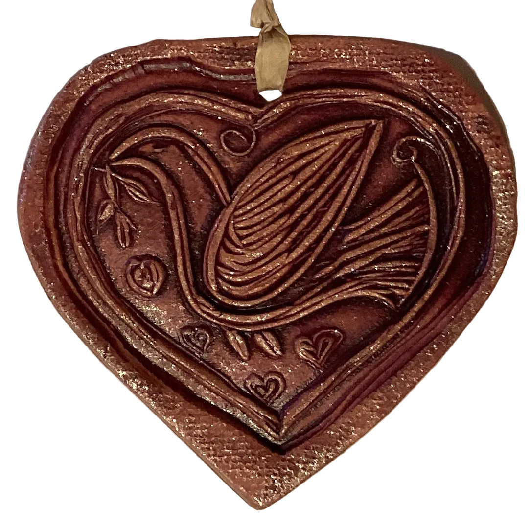 Handmade clay themed decorative ornaments from Ysleta Mission Gift Shop, featuring colorful designs for home and garden decor.
