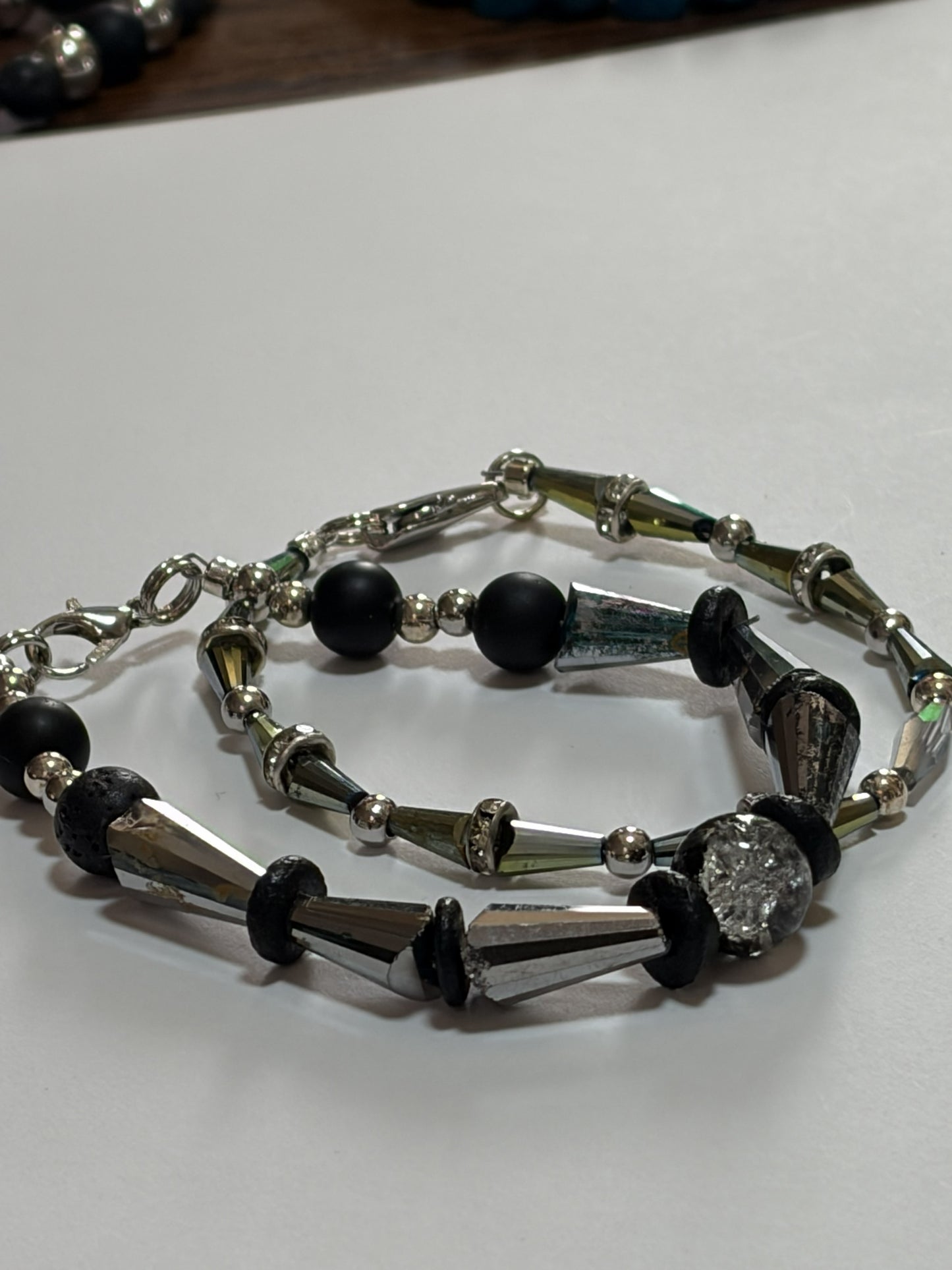 Silver beaded couples bracelet with 10mm natural stone, black onyx, silver spacers, and crackle glass beads, 20-inch length.