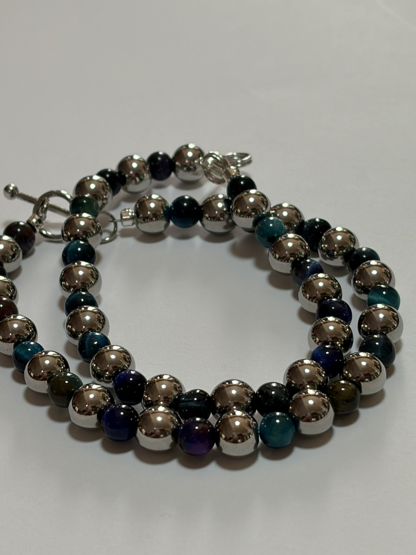 Blue stone couples bracelet set by Sylvia Leroux featuring 8mm stretch band, stainless steel with silver finish and lobster clasp.
