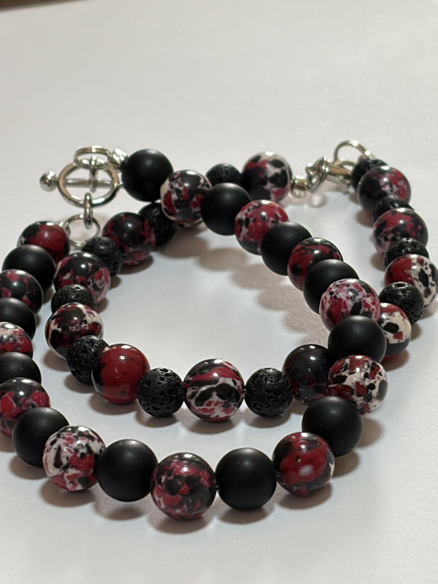 Natural stone bracelet set by Sylvia Leroux featuring 8mm black and red Jasper beads with silver lobster and toggle clasps for couples.