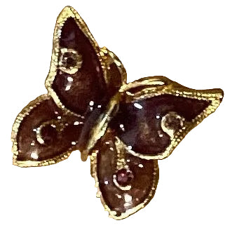 Purple and gold butterfly brooch featuring Catholic Christian jewelry design, showcasing intricate metalwork and vibrant colors.