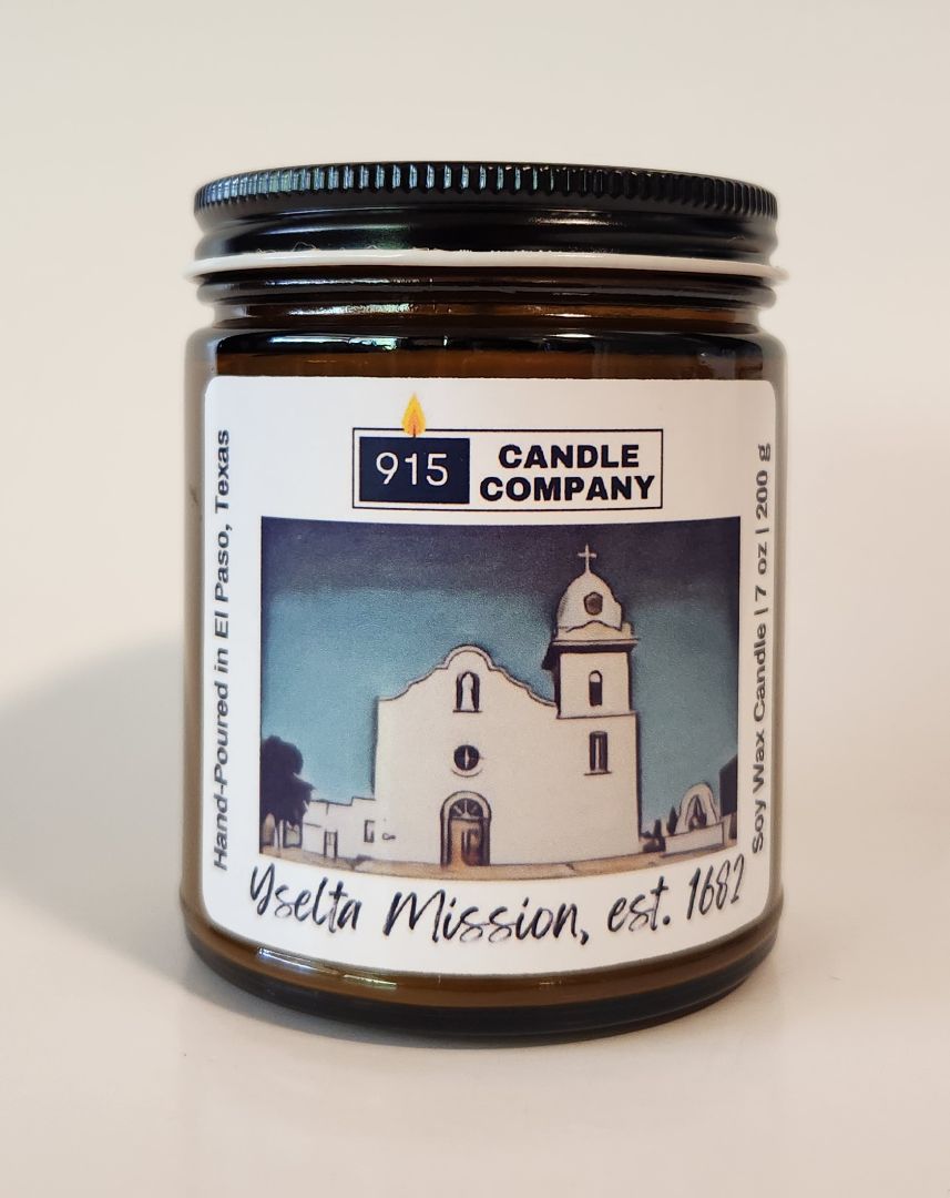 Hand-poured 7 oz Karin Melson Ysleta Mission scented candle with a decorative label, perfect for home ambiance.