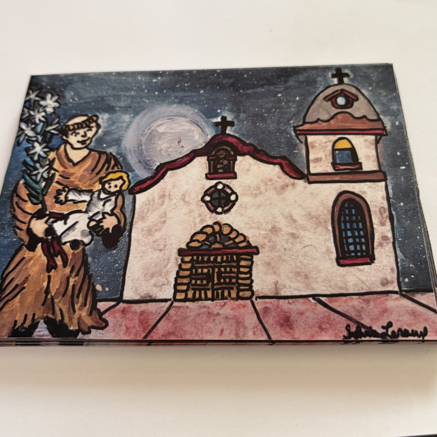 Smiley Saint Anthony magnet featuring Ysleta Mission art, a collectible El Paso souvenir by Sylvia Leroux.