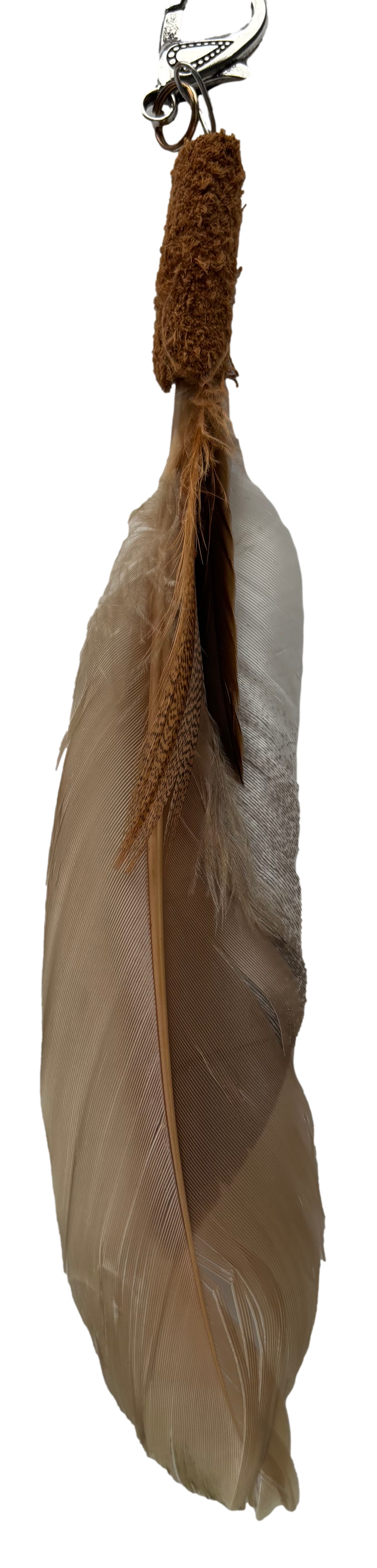 Brown feather tassel keychain accessory by Consuelo Barraza, with soft feathers and a stylish design for bags and wallets.