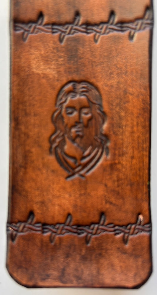 Brown leather Jesus bookmark by Consuelo Barraza featuring detailed religious artwork, ideal for book lovers and home decor.