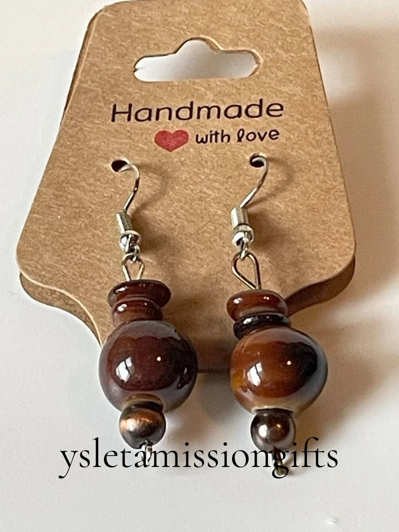 Ceramic brown and shell bead dangle earrings by Sylvia Leroux, 2 inches long, featuring natural earthy tones and intricate beadwork.