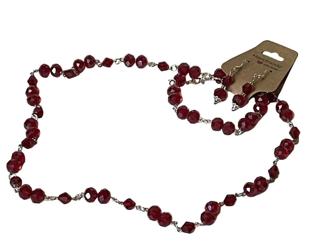 Deep red faceted bead jewelry set including necklace, bracelet, and earrings by Sylvia Leroux, 24-inch length.