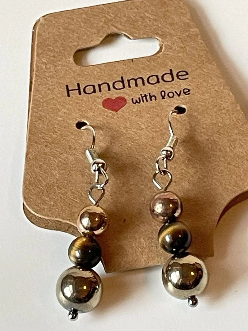 Gold metal and tiger eye dangle earrings by Sylvia Leroux, 1.5 inches long, featuring polished tiger eye stones and elegant metalwork.