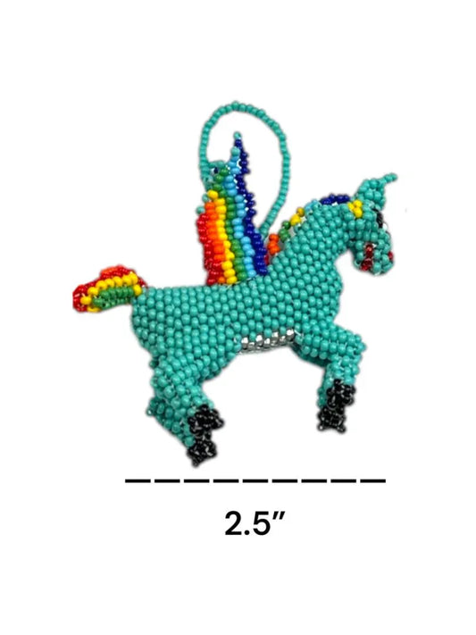 Handcrafted beaded unicorn charm with Mexican embroidery and tassel, designed as a bag accessory by Jose Alberto Chavez.