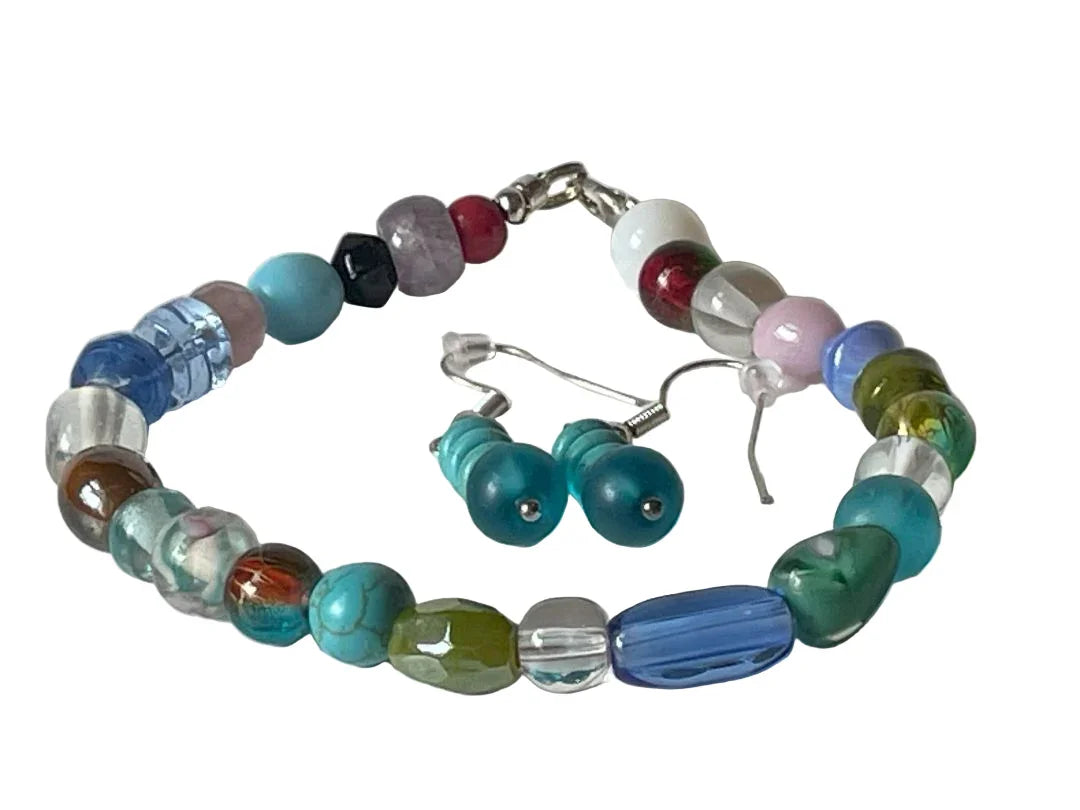 Mixed glass bead bracelet and turquoise earrings set by Sylvia Leroux, featuring vibrant beads and stylish jewelry accessories.