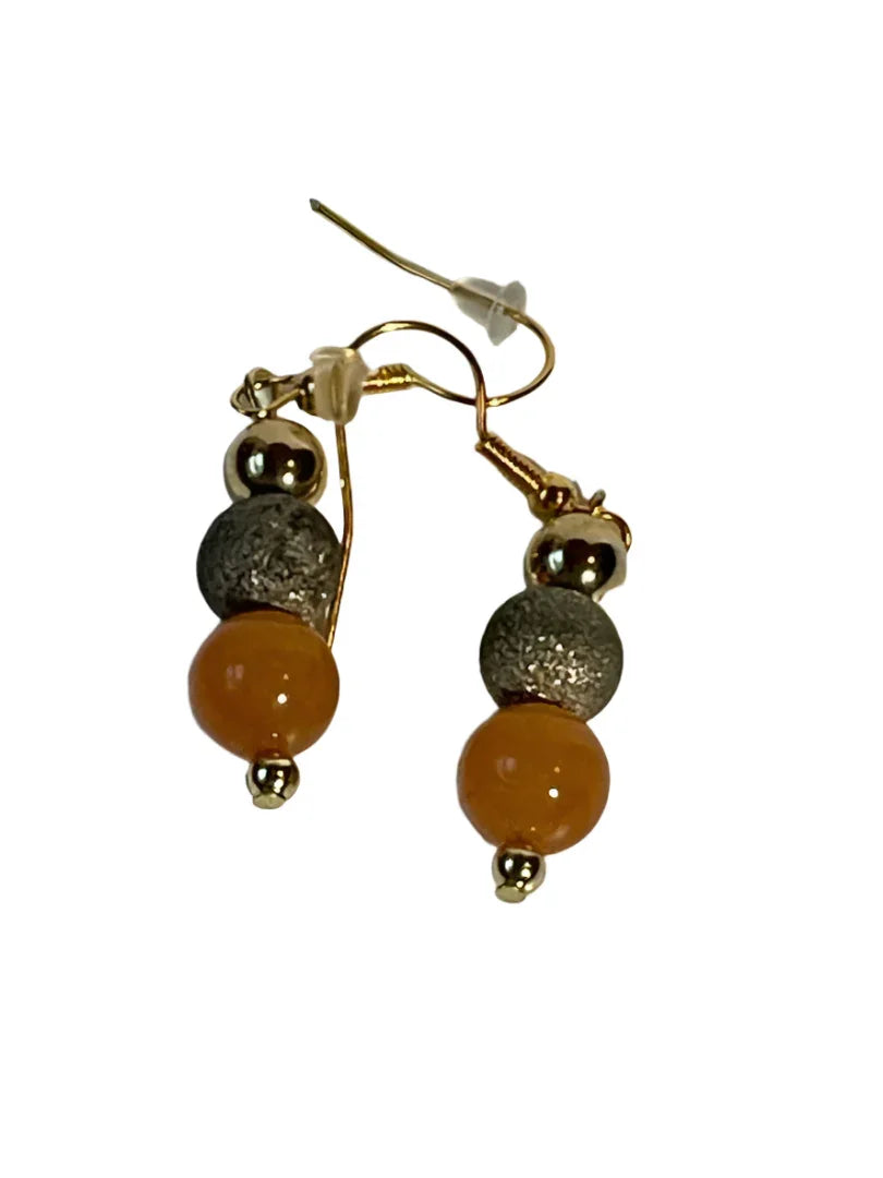 Orange stone earrings with gold glitter accents, 1-inch dangle earrings by Sylvia Leroux featuring vibrant orange stones and shimmering gold details.