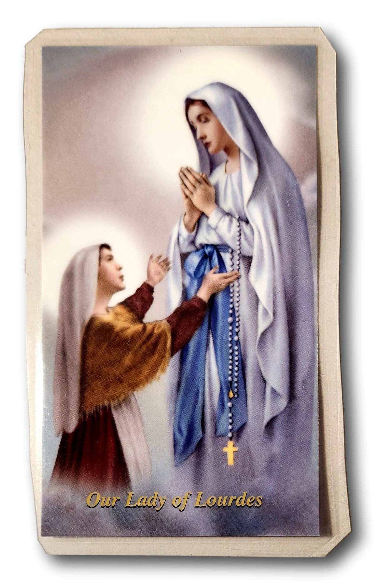 Laminated Catholic prayer card featuring Our Lady of Lourdes with religious imagery, suitable for Christian devotion.