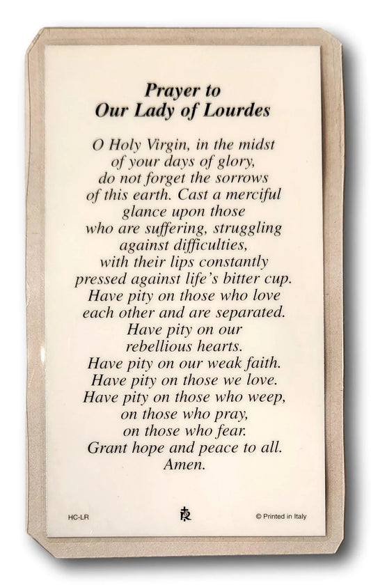 Laminated Catholic prayer card featuring Our Lady of Lourdes with religious imagery from Ysleta Mission Gift Shop.