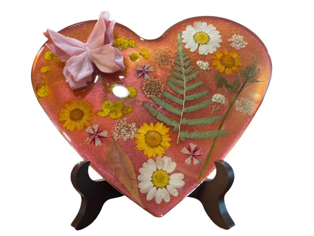 Resin hearts with dried flowers artwork by Brigitte Rosson, featuring an easel for display, suitable for home and garden decor.