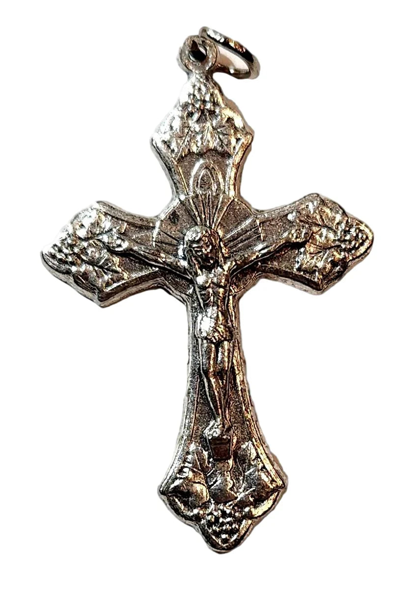 Silver crucifix pendant with detailed figure of Jesus and floral engravings on cross