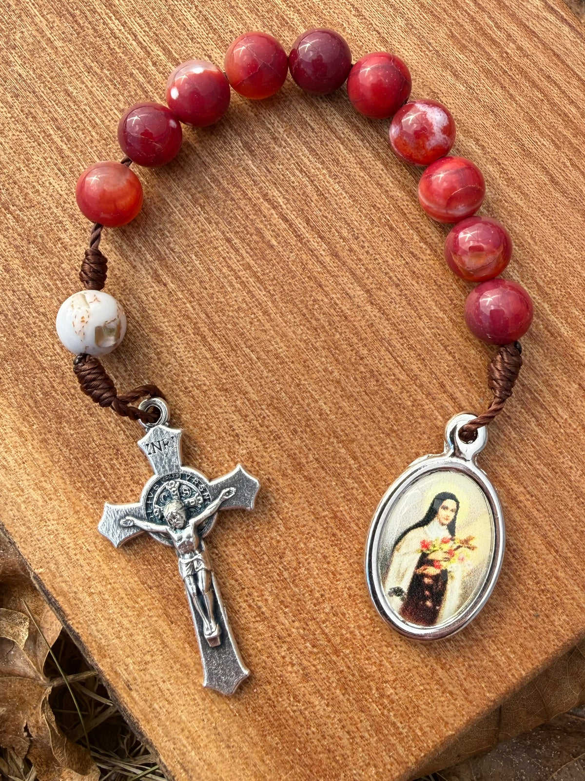 Catholic pocket rosary with red agate beads and Saint Therese pendant, designed for Christian prayer and devotion by Liza Murphy.
