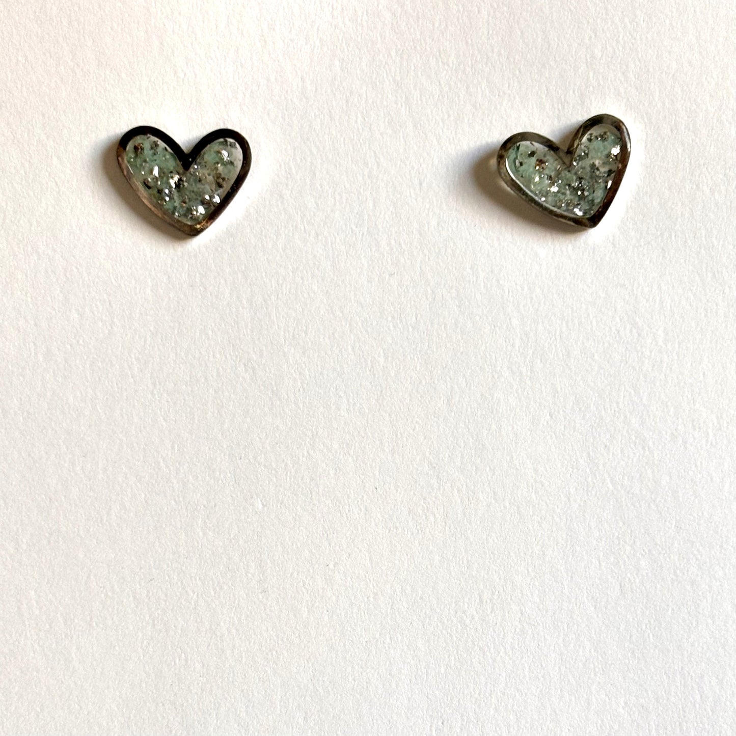 Silver stainless steel heart stud earrings with blue glitter resin from Melissa Cortinas, jewelry and accessories.