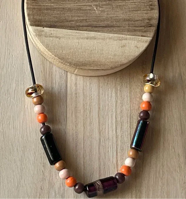 Brown and orange wooden bead necklace with glass beads on black cord, artisan style jewelry by Sylvia Leroux.