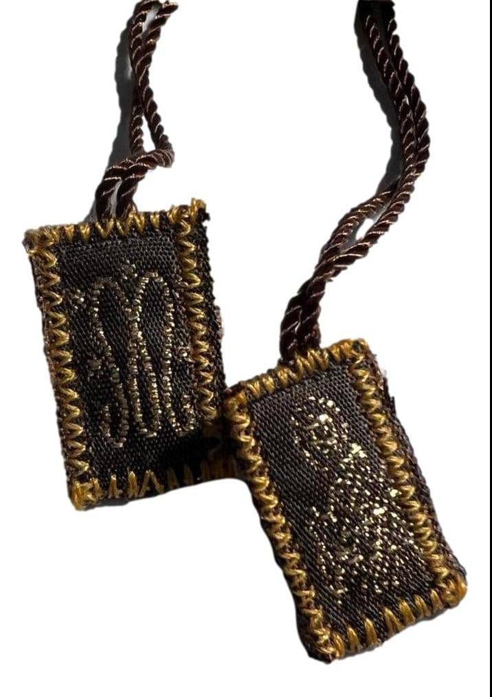 Brown wool cord scapular with gold embroidered edges and religious symbols on black fabric