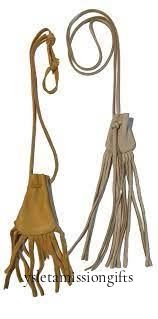 Two handcrafted Native American medicine pouches made of elk hide with fringes and leather straps