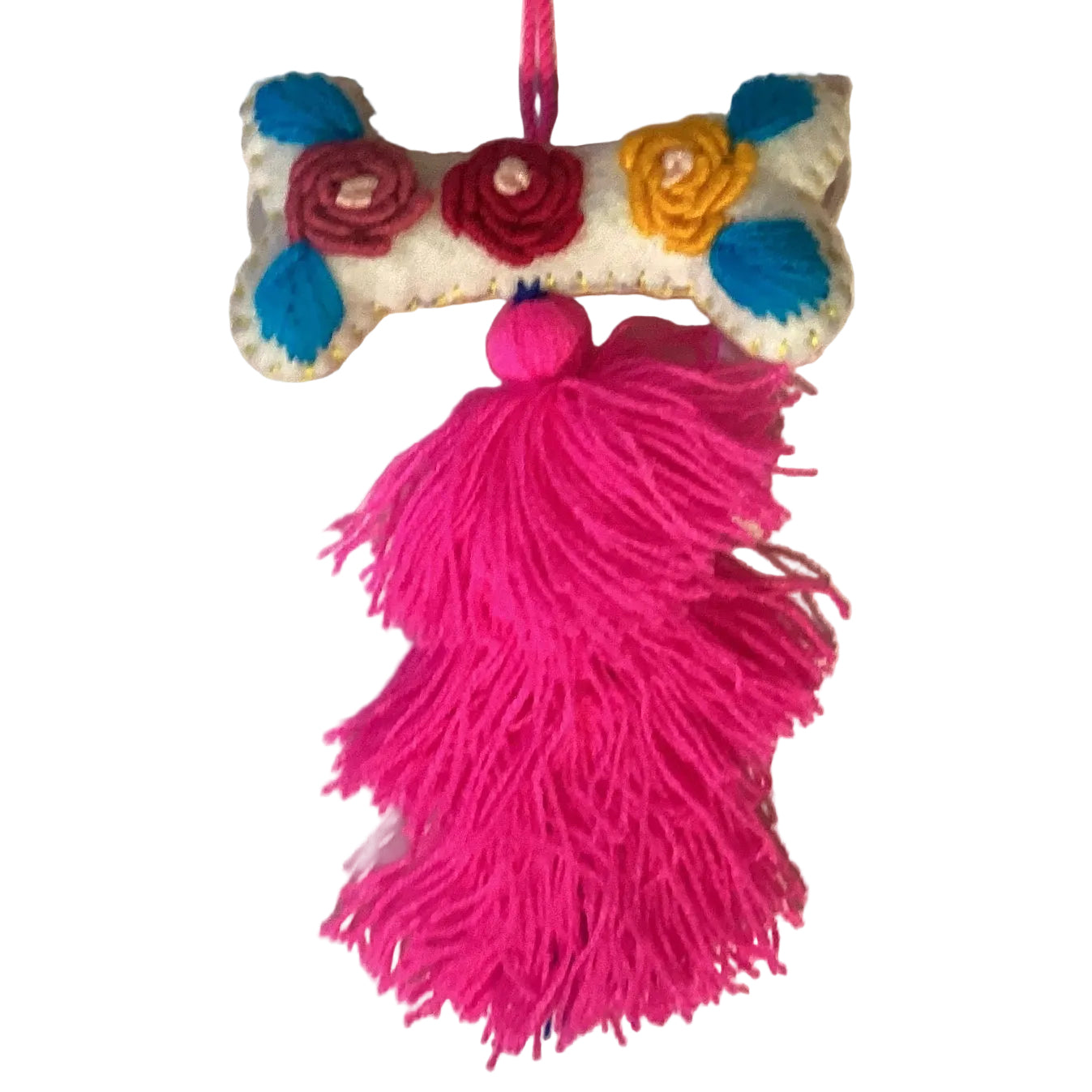 Handcrafted Mexican embroidered dog bone charm with tassel, artisan accessory from Jose Alberto Chavez, suitable for bags and apparel.