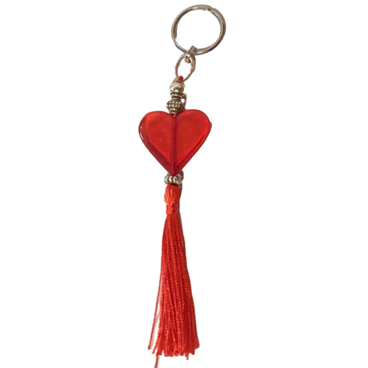 Red heart and tassel keychain with loop from Ysleta Mission Gift Shop, featuring vibrant fabric and decorative details.