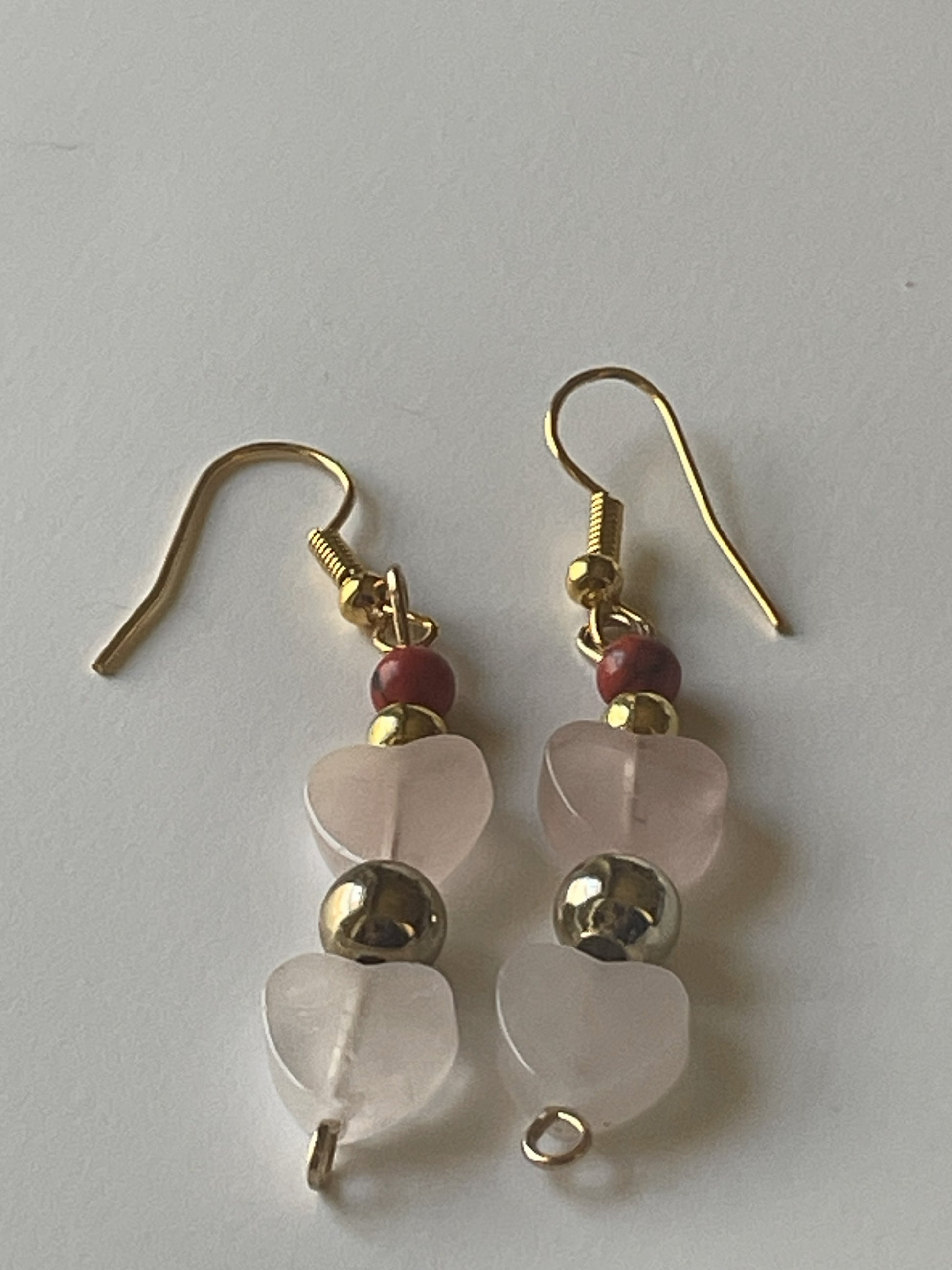 Red stone and rose quartz heart dangle earrings by Sylvia Leroux featuring 2-inch gold hooks and beaded design.