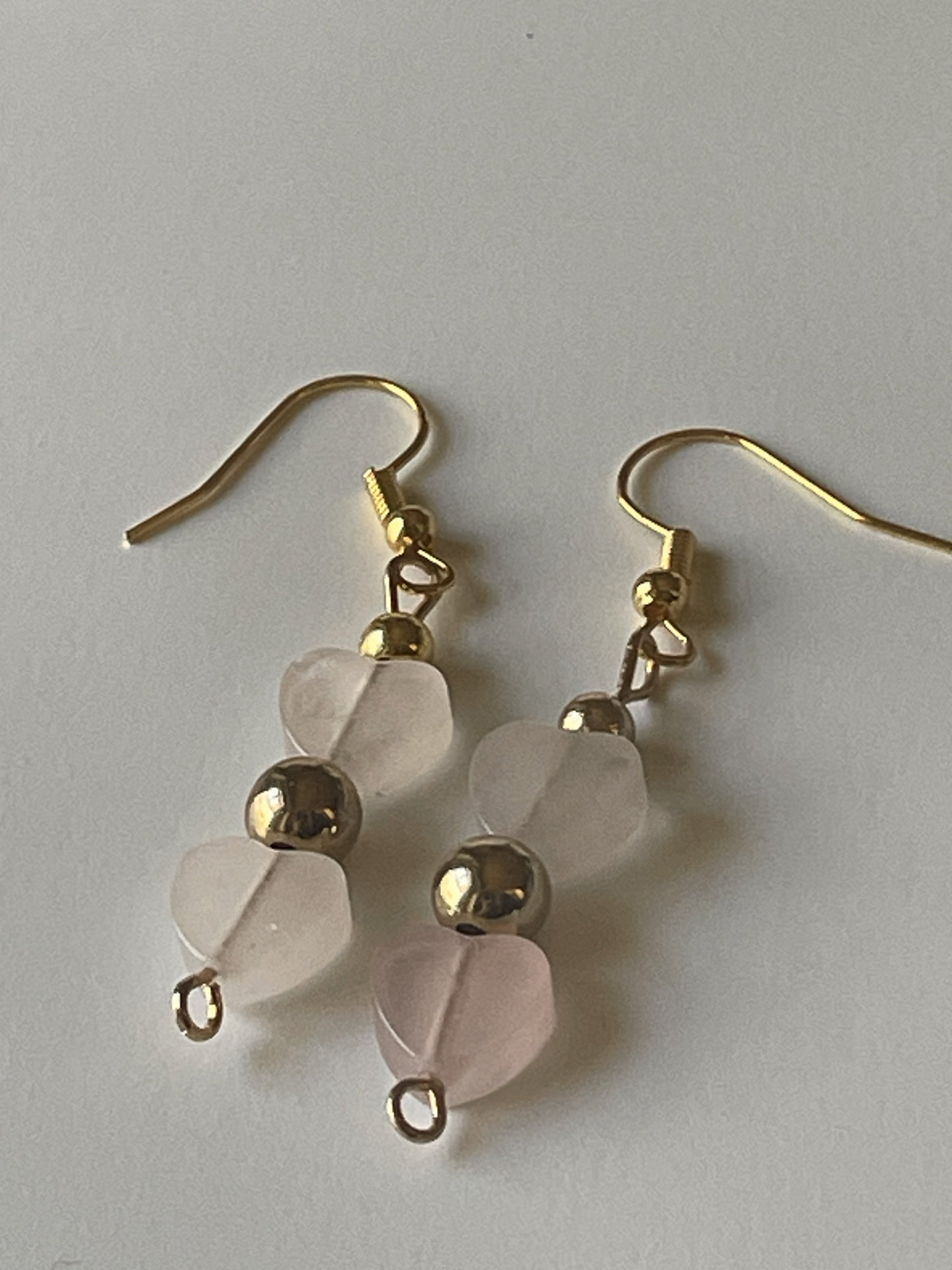 Rose quartz heart dangle earrings with gold spacer beads and hooks, Sylvia Leroux jewelry, 2-inch length, elegant and feminine style.