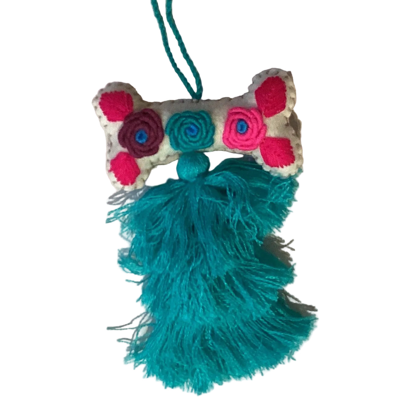 Handcrafted Mexican embroidered dog bone charm with tassel, artisan accessory from Jose Alberto Chavez, ideal for bag decoration.