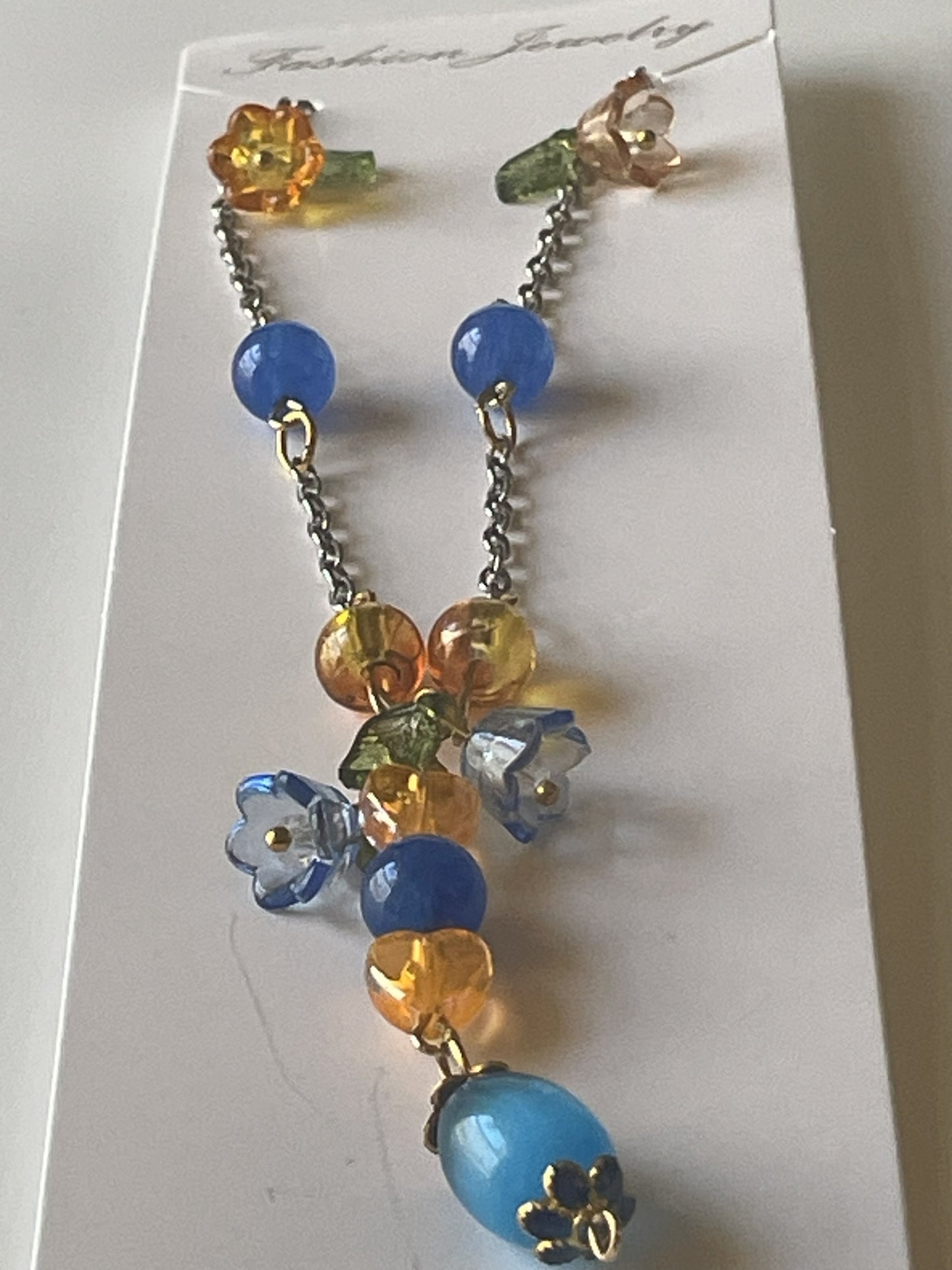 Silver gold chain necklace by Sylvia Leroux featuring 8mm blue Kyanite beads, acrylic flowers, heart beads, and glass accents.