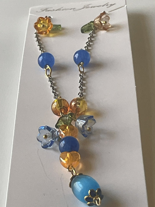 Silver gold chain necklace by Sylvia Leroux featuring 8mm blue Kyanite beads, acrylic flowers, heart beads, and glass accents.