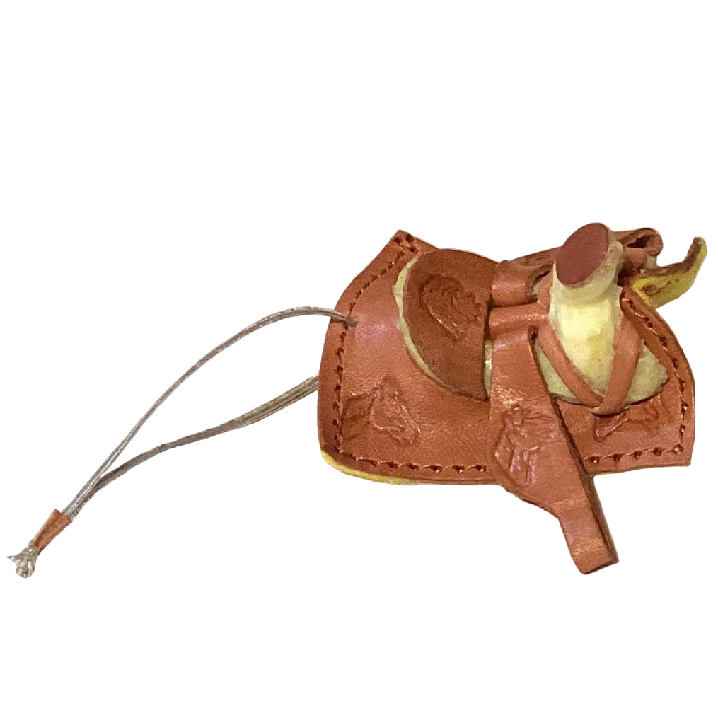 Mini leather saddle keychain featuring a Western cowboy design, ideal as a gift, from Ysleta Mission Gift Shop.