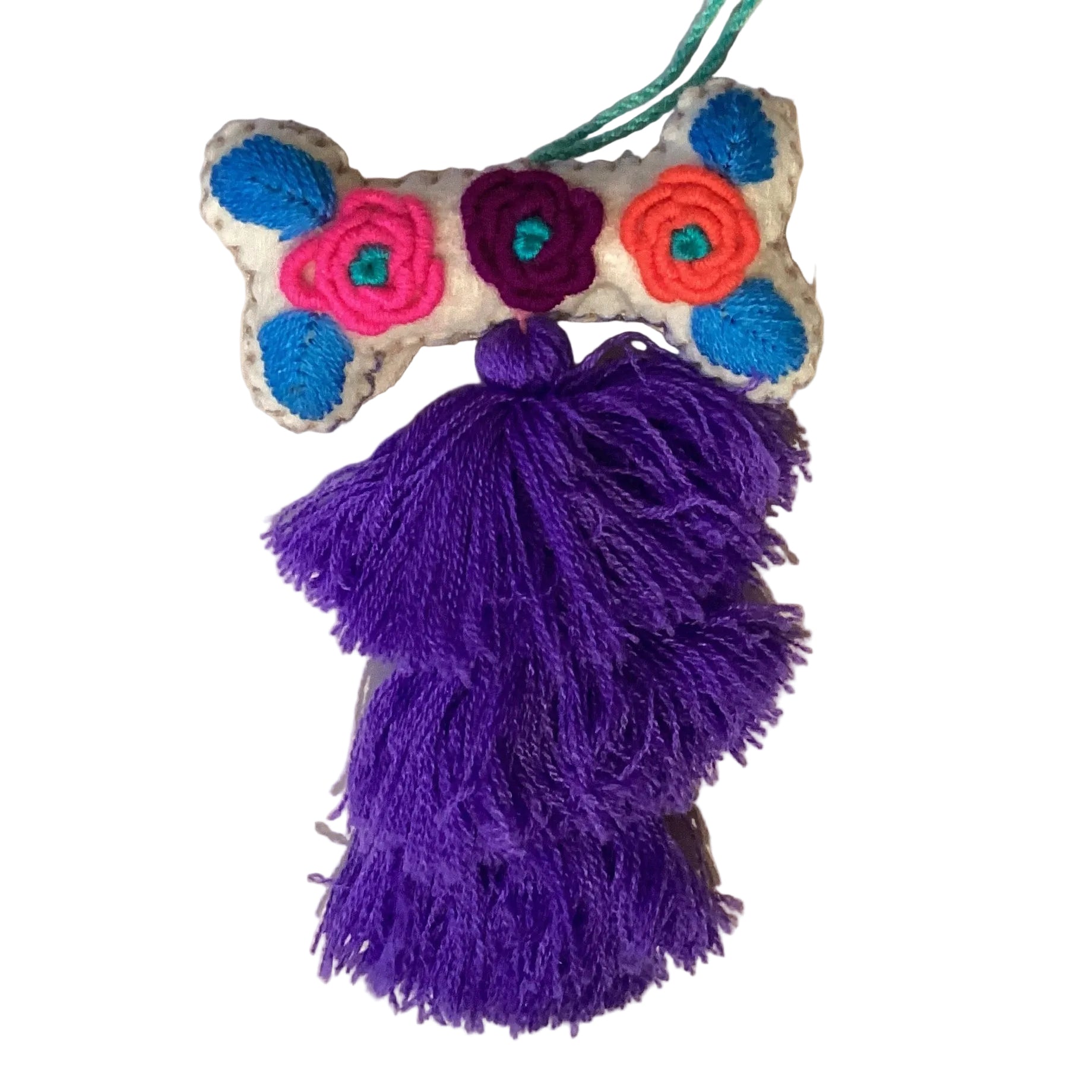 Handcrafted Mexican embroidered dog bone charm tassel accessory by Jose Alberto Chavez, featuring vibrant embroidery and tassel details.