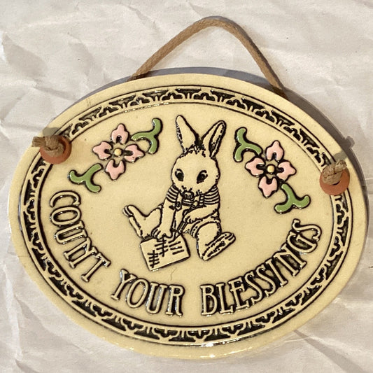 Vintage ceramic wall decor with "Count Your Blessings" inscription, featuring colorful floral design, by Ysleta Mission Gift Shop.