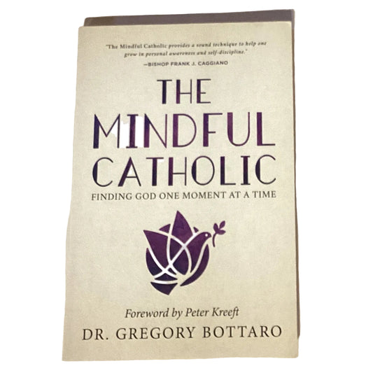 Open book titled "The Mindful Catholic: Finding God One Moment at a Time," Catholic faith and devotion book by Ysleta Mission Gift Shop.