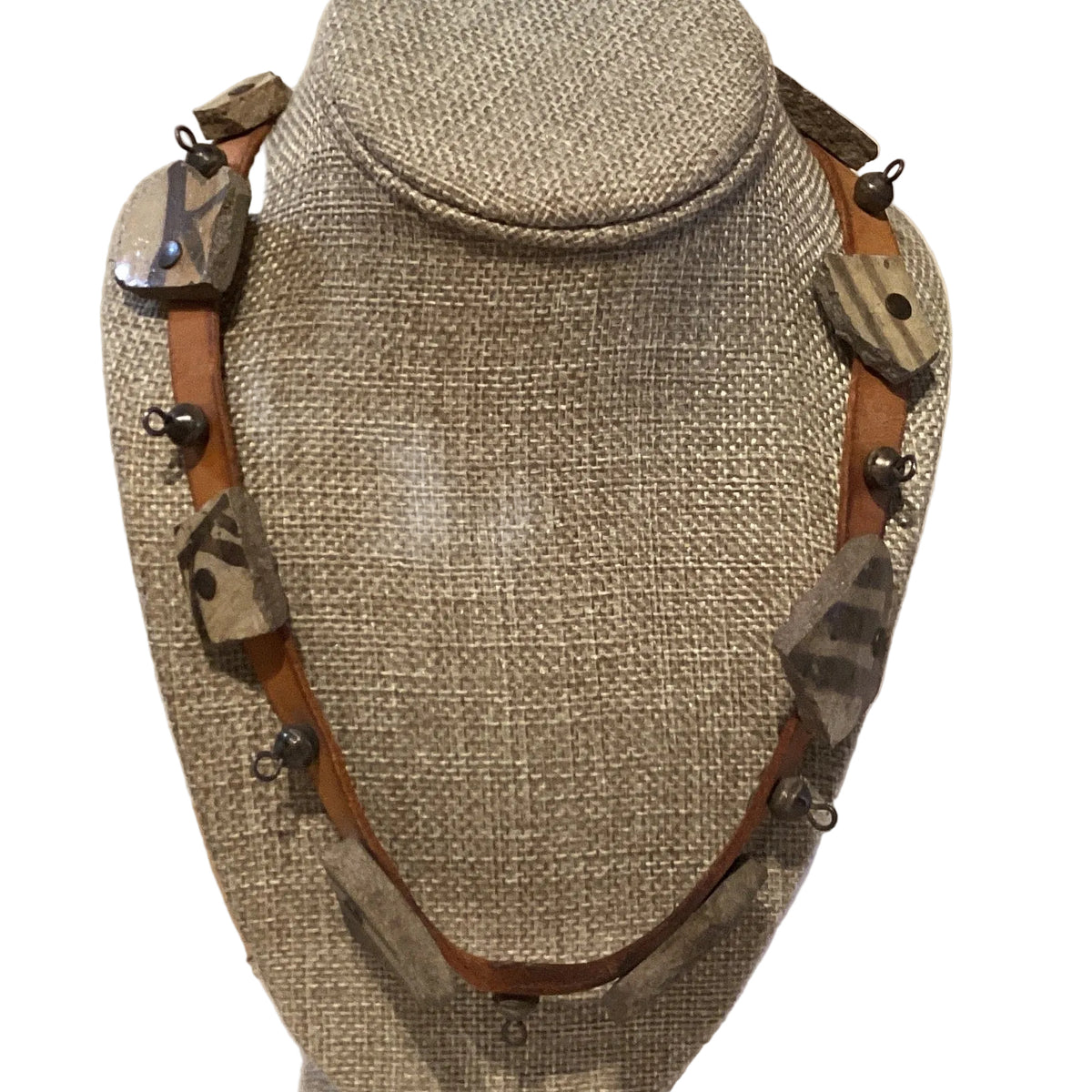 Handmade pottery shard and leather band statement necklace with 20-inch length, featuring rustic ceramic and leather details.