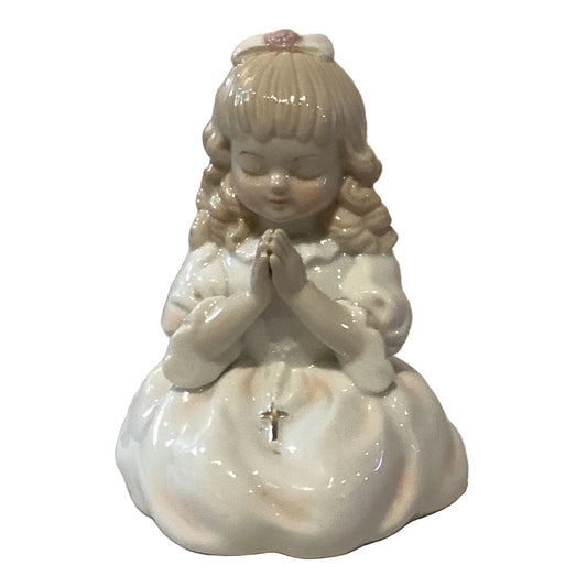 Porcelain praying girl figurine from Ysleta Mission Gift Shop, showcasing a delicate girl with hands clasped in prayer.