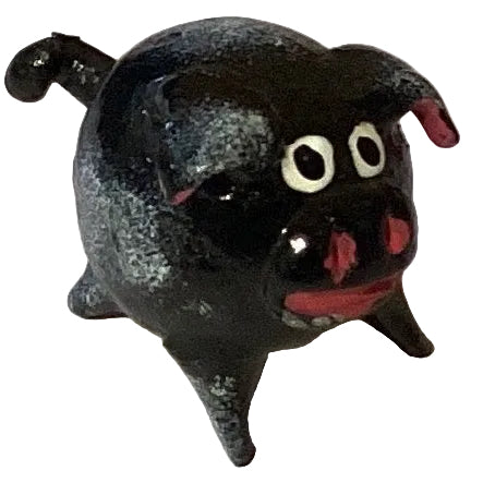 Cute pig figurine with a floating tail, designed for home decor and garden accents, from Ysleta Mission Gift Shop.