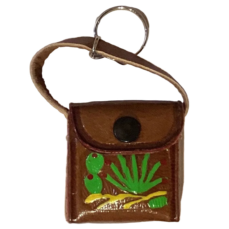 Mini leather crossbody purse keychain in western style with Ysleta Mission Gift Shop branding, featuring detailed leather craftsmanship.