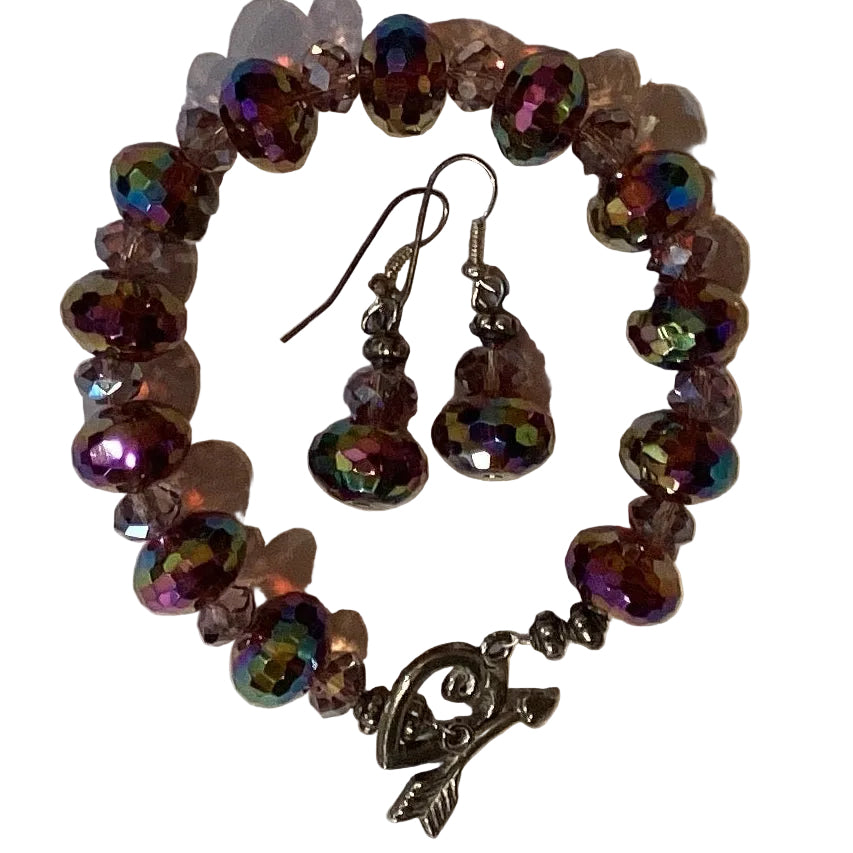 Purple beaded jewelry set with silver hardware including a bracelet and earrings, featuring intricate beadwork and jewelry design.