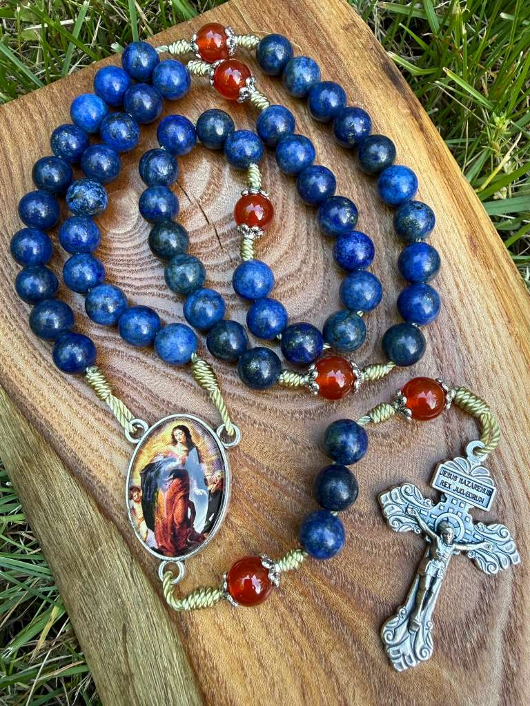 Catholic rosary with lapis lazuli and carnelian beads, featuring an Assumption of Mary centerpiece and a Pardon crucifix.