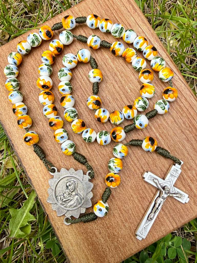 Porcelain sunflower Marian Catholic rosary with ornate five-decade design and Marian centerpiece, crafted by Liza Murphy.