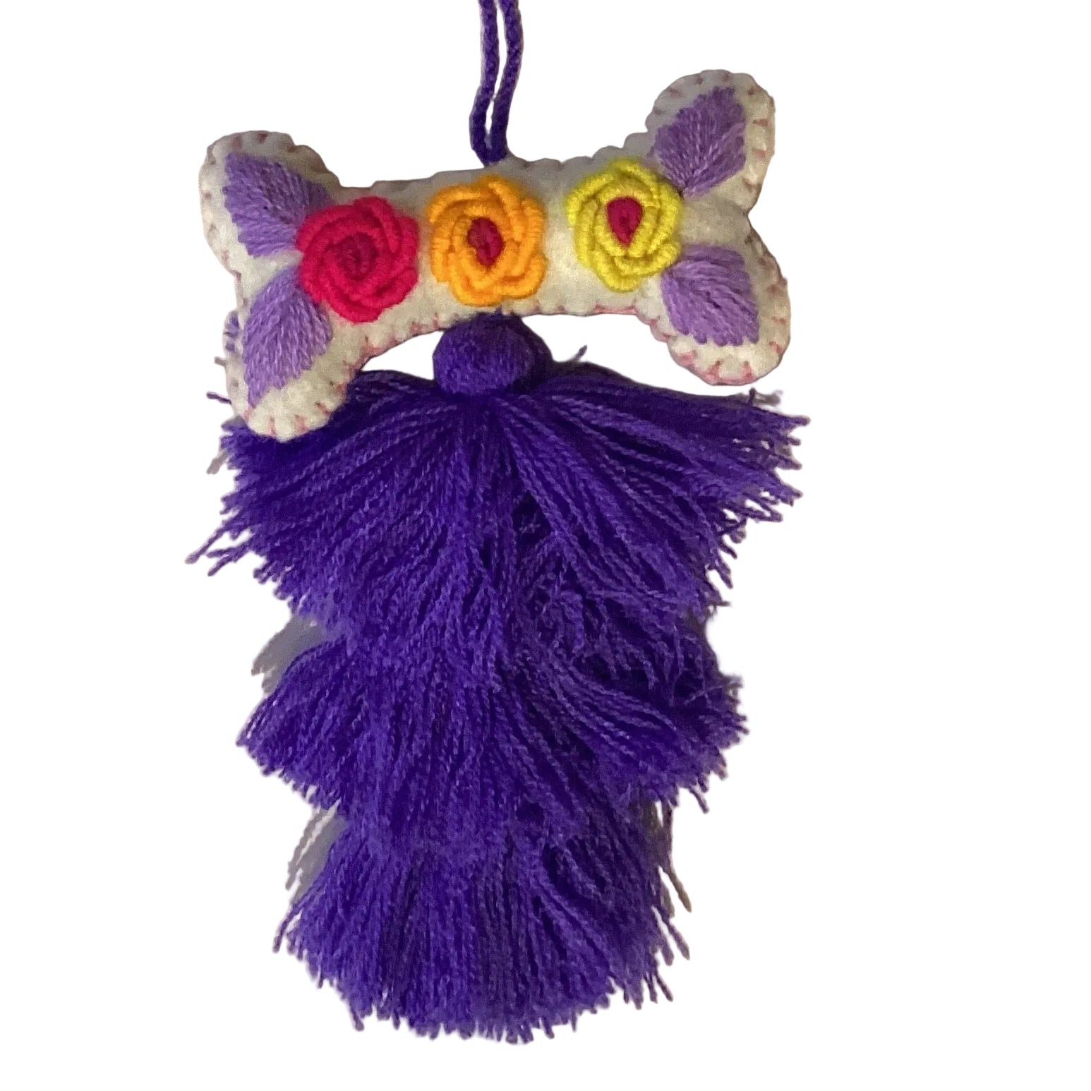 Handcrafted Mexican embroidered dog bone charm with tassel, artisan accessory by Jose Alberto Chavez, featuring colorful traditional embroidery.